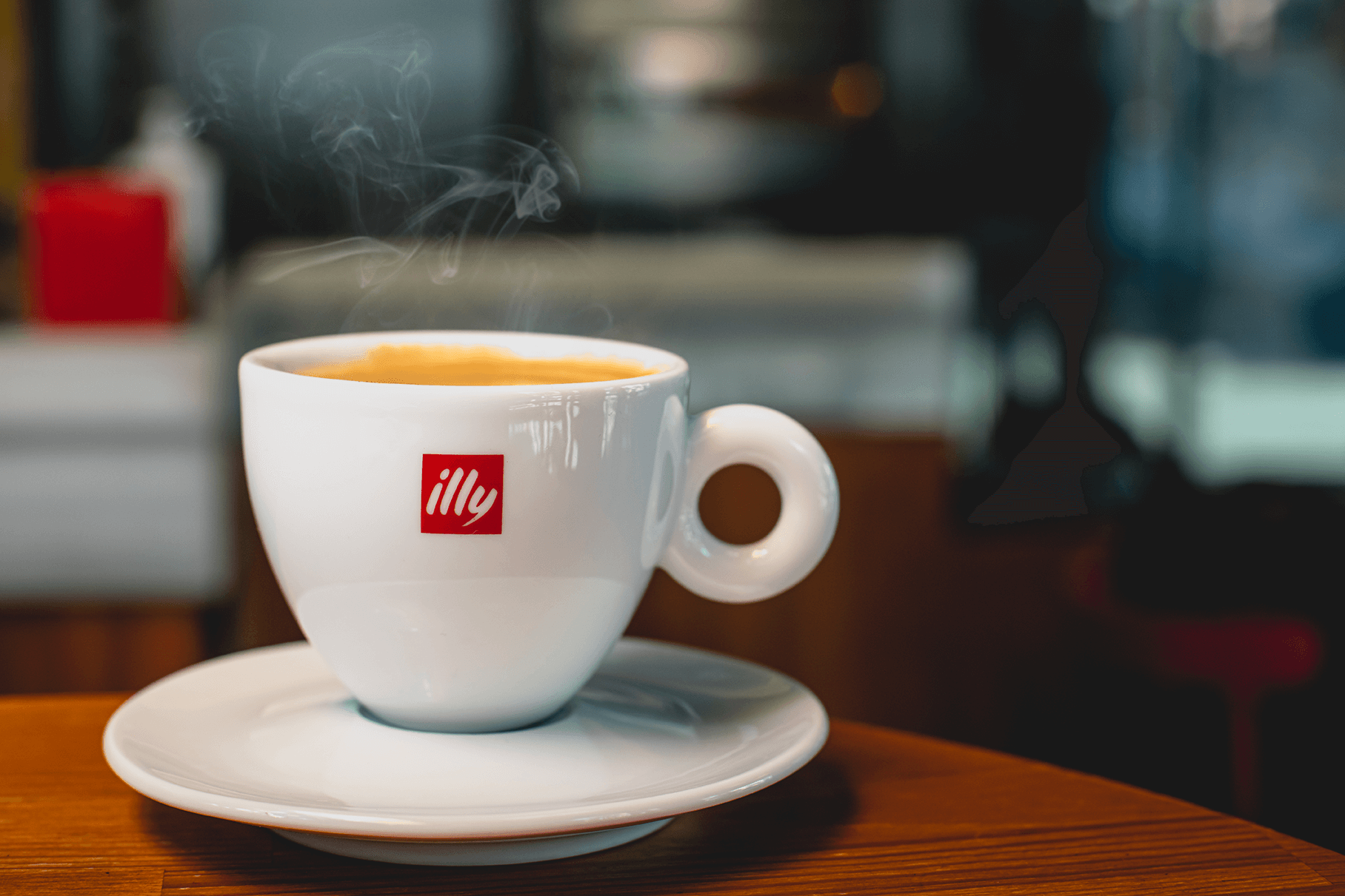 A fresh Illy Coffee in a white branded mug-1