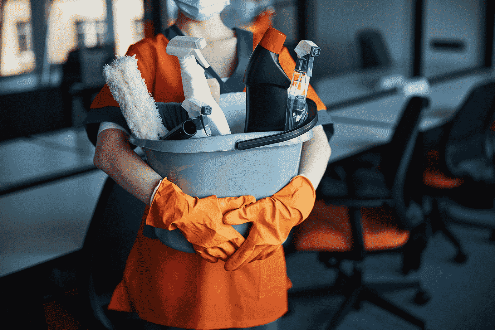 a closeup shot of a cleaner holding a bucket of cleaning supplies[1]-min