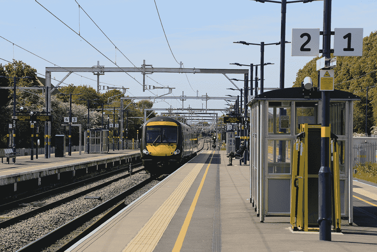 a train arrives at a station in sunny weather-min